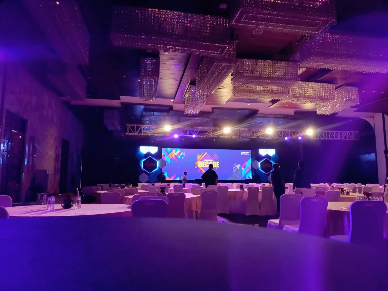 Large corporate ballroom with premium staging and chandeliers